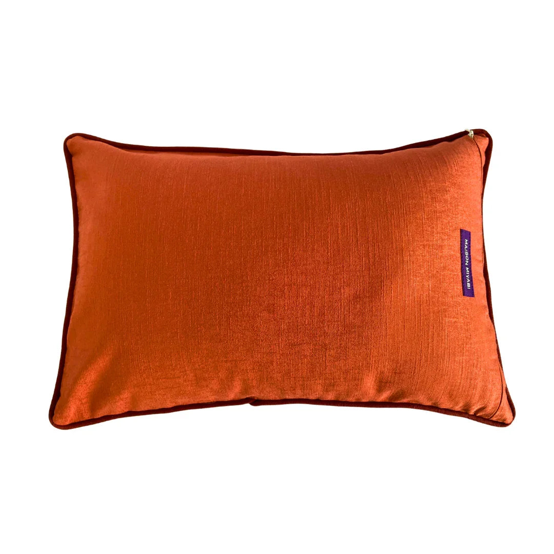 Rectangular orange silk cushion with subtle sheen and fabric tag, Japanese Parisian home decor
