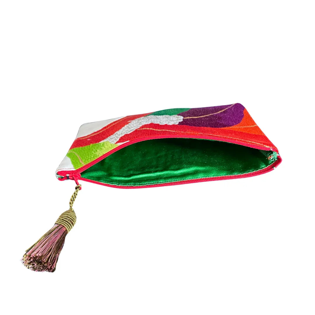 Colorful vintage obi kimono fabric pouch with tassel and green interior, open view