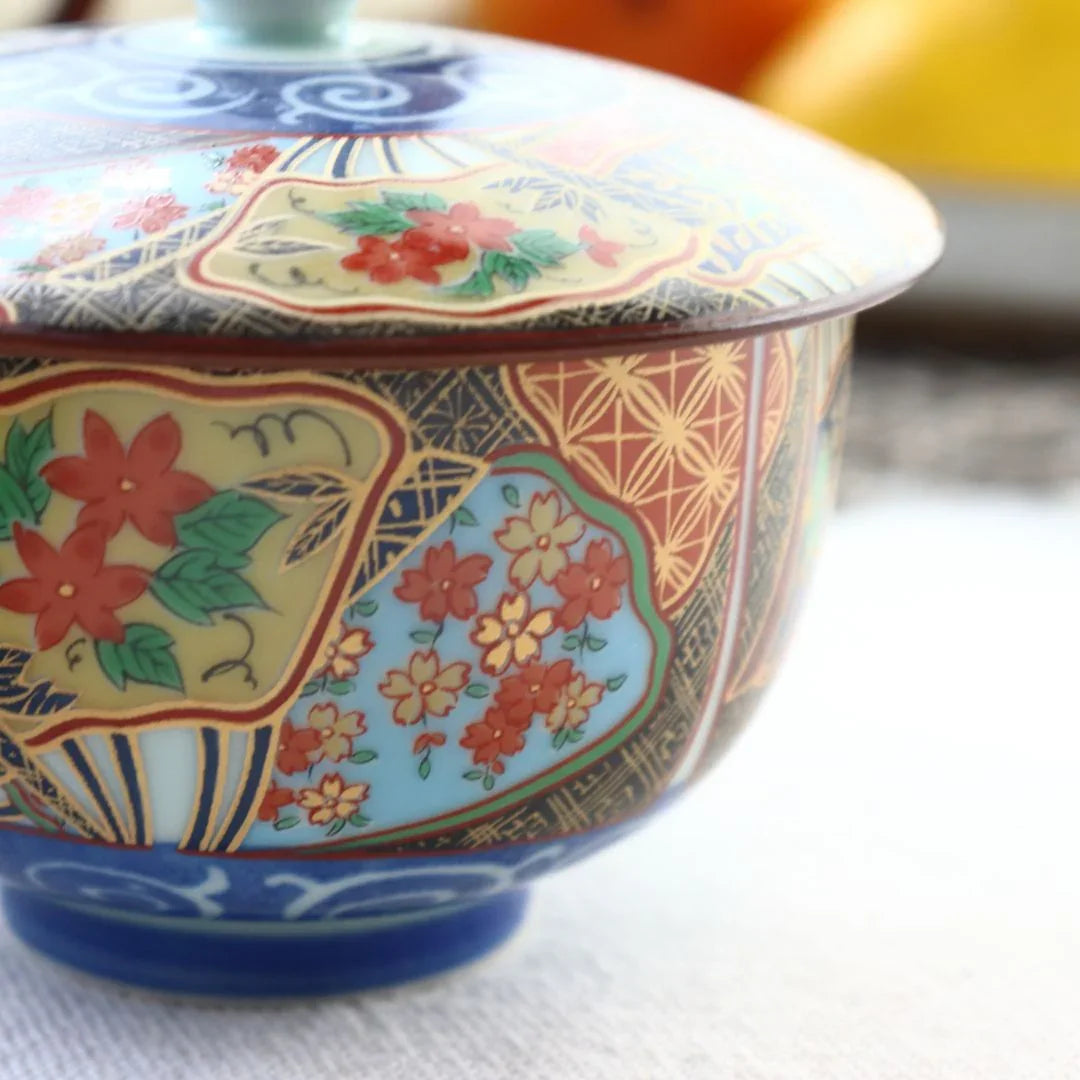 Kutani porcelain bowl with intricate floral patterns and vibrant colors on table
