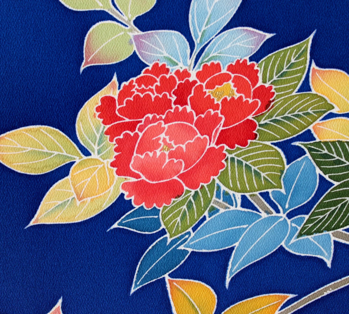 Vintage Japanese kimono obi fabric with red camellia and colorful leaves on blue background