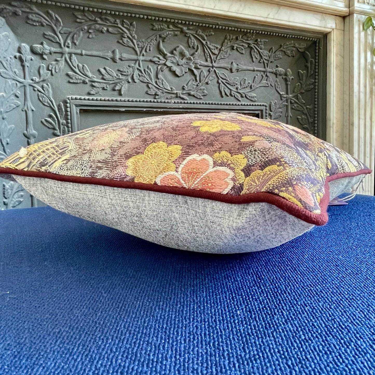 Obi-Kimono vintage cushion with floral embroidery on a blue sofa, elegant Japanese decor