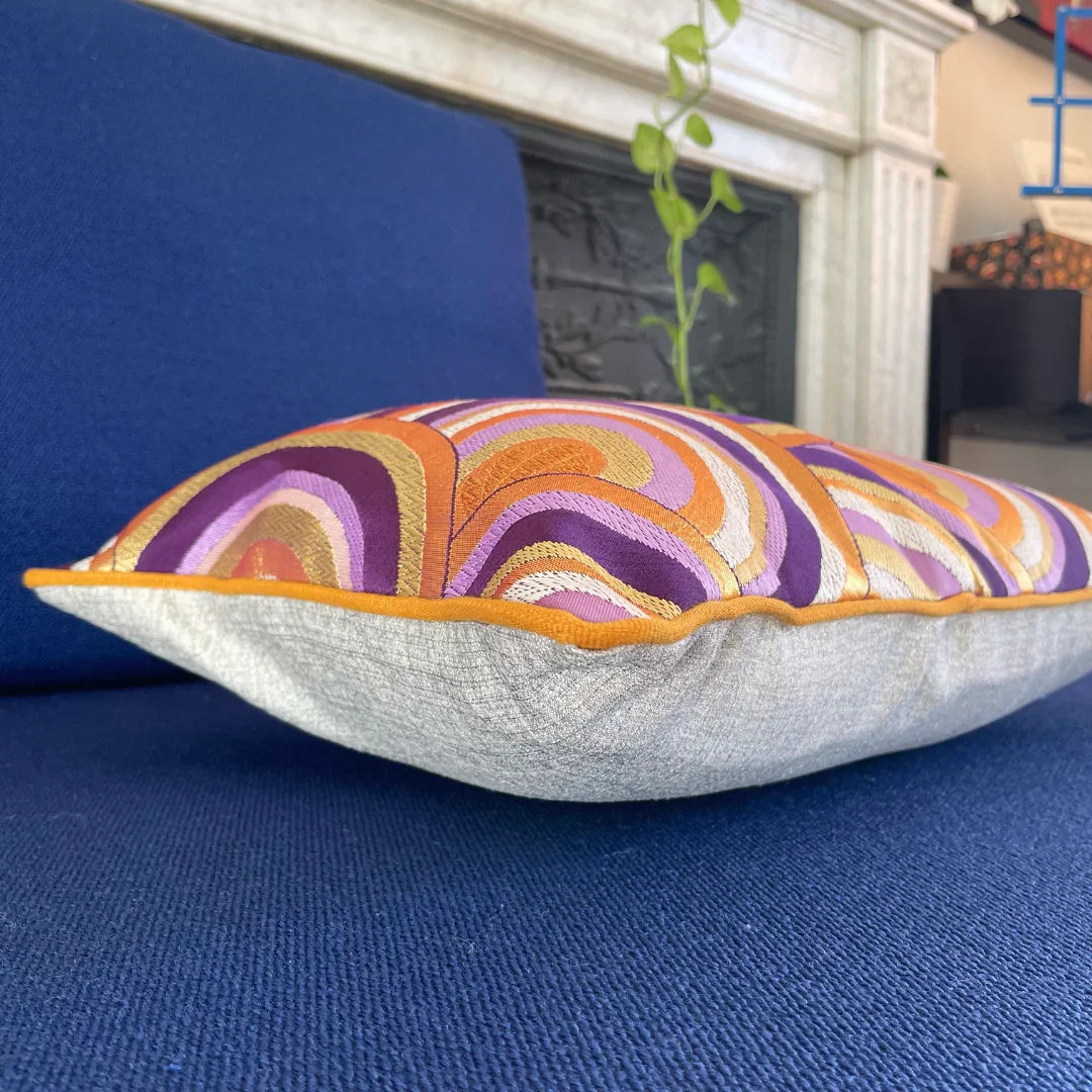 Vintage Japanese Obi-Kimono cushion with purple, gold, and orange patterns on blue sofa