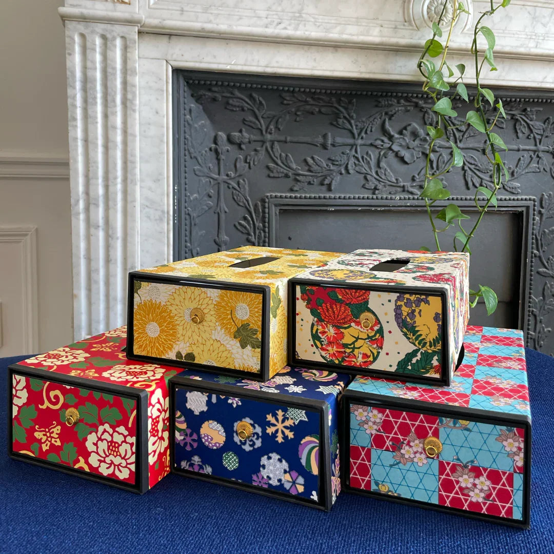 Stack of colorful Japanese obi-kimono patterned boxes with floral and geometric designs