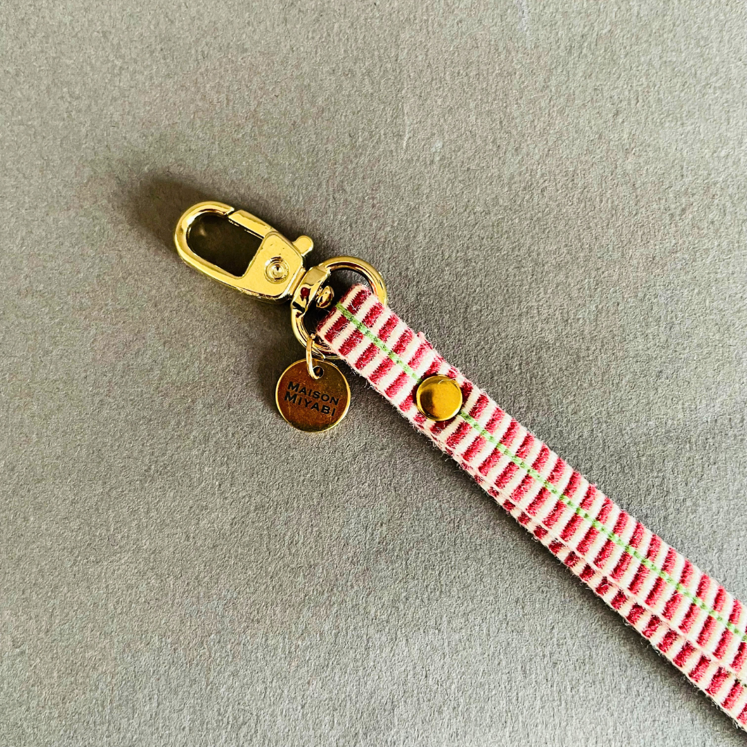 Striped fabric strap with gold clasp and charm in red and white by MAISON MIYABI Paris